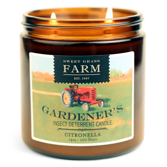 A jar of Gardener's insect deterrent candle with a label featuring a red tractor and the name 'Citronella'.
