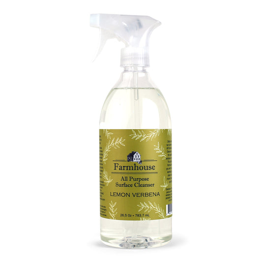 A clear spray bottle labeled 'Farmhouse' with 'All Purpose Surface Cleanser' and 'Lemon Verbena' scent, containing a plant-based cleaner.