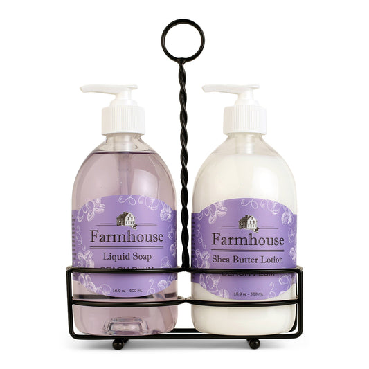 A black metal caddy holding two bottles, one labeled as 'Farmhouse Liquid Soap' and the other as 'Shea Butter Lotion', in Beach Plum scent