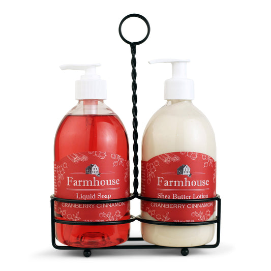 A black metal caddy holding two bottles, one labeled as 'Farmhouse Liquid Soap' and the other as 'Shea Butter Lotion', in Cranberry Cinnamon scent
