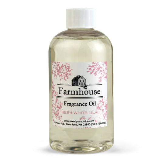 A refill bottle of Farmhouse fragrance oil labeled 'Fresh White Lilac', intended for use with diffuser sticks.
