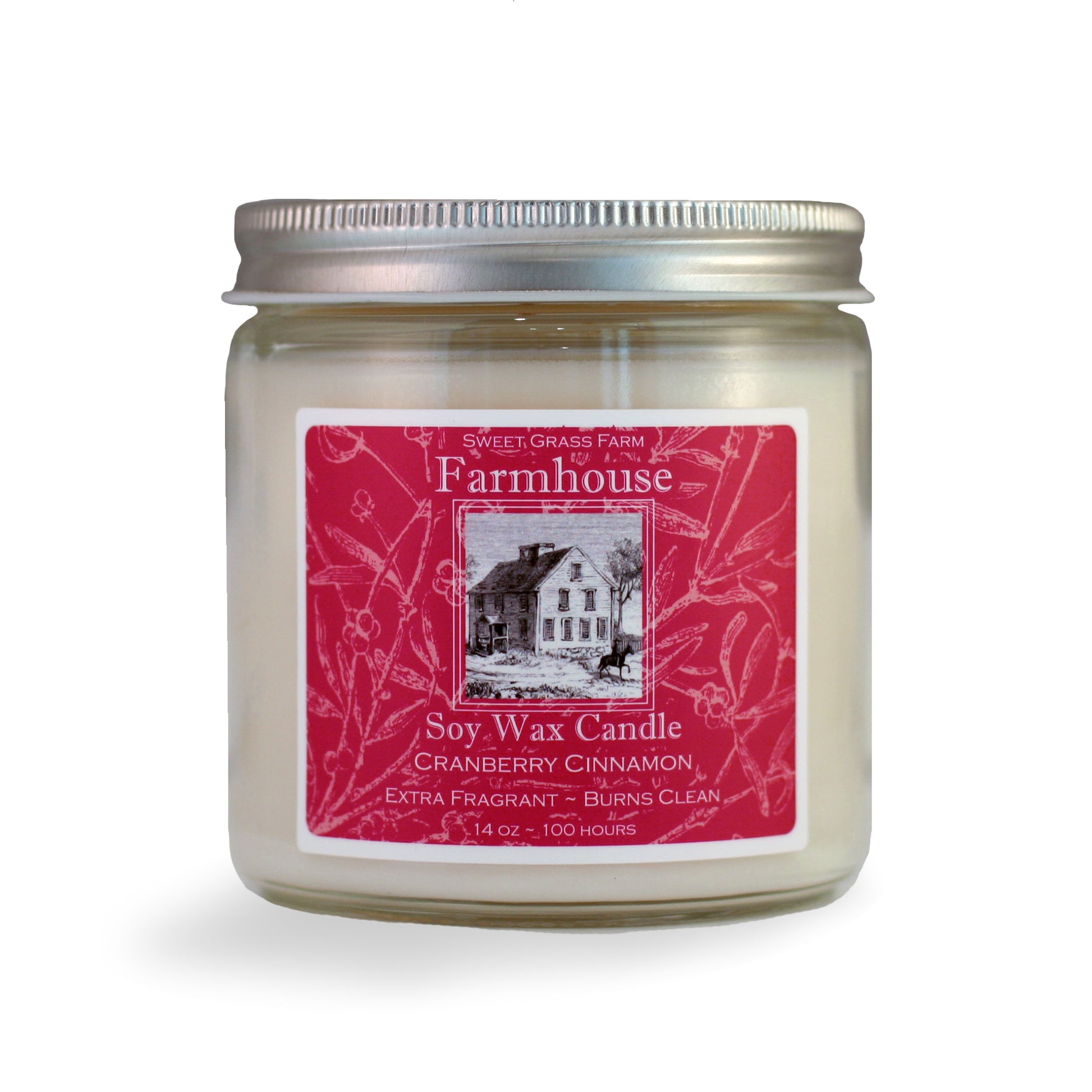 A soy wax candle jar with a label that reads 'Farmhouse Soy Wax Candle, Cranberry Cinnamon, Extra Fragrant - Burns Clean', with a picture of a house and the brand name 'Sweet Grass Farm'.