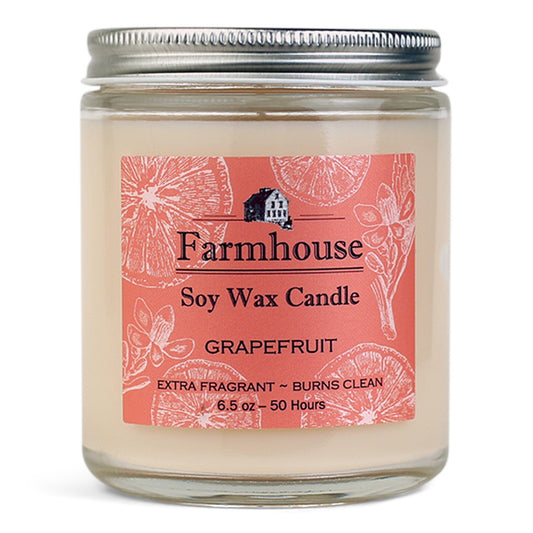 Farmhouse soy wax candle with grapefruit fragrance on an orange label