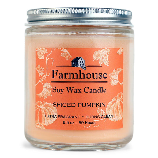 Farmhouse soy wax candle with spiced pumpkin fragrance on an orange label