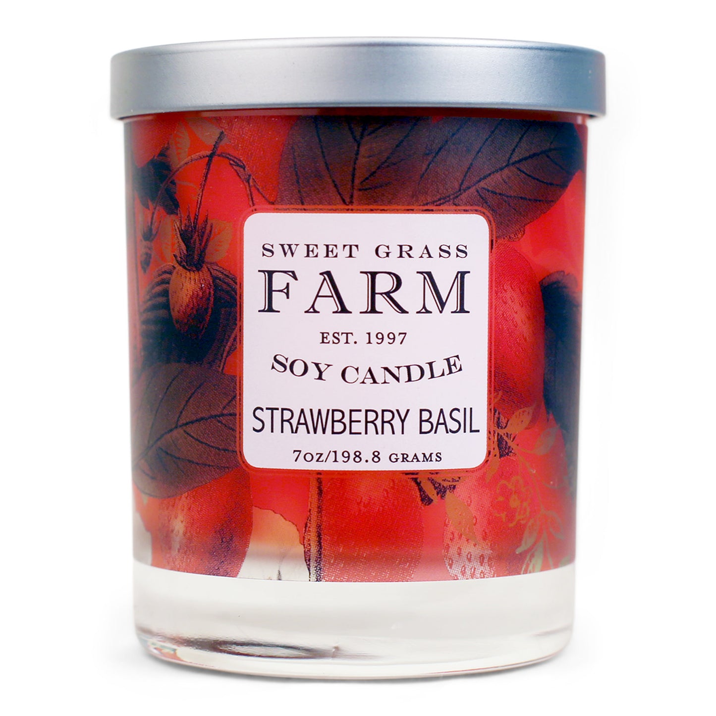 A soy wax candle in a clear tumbler with a label that reads 'Sweet Grass Farm Soy Candle, Strawberry Basil', with red and green botanical images in the background.