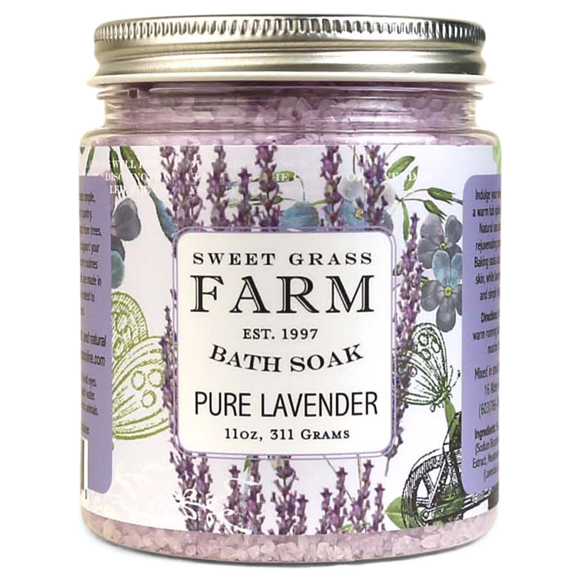 A jar of Sweet Grass Farm bath soak with a label that reads 'BATH SOAK PURE LAVENDER 11oz, 311 Grams'. The jar is filled with purple bath salts.