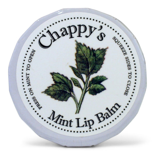 A round metal tin of Chappy's Mint Lip Balm, with a label featuring green leaves and the product name.