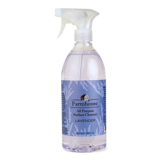 A clear spray bottle labeled 'Farmhouse' with 'All Purpose Surface Cleanser' and 'Lavender' scent, containing a plant-based cleaner.