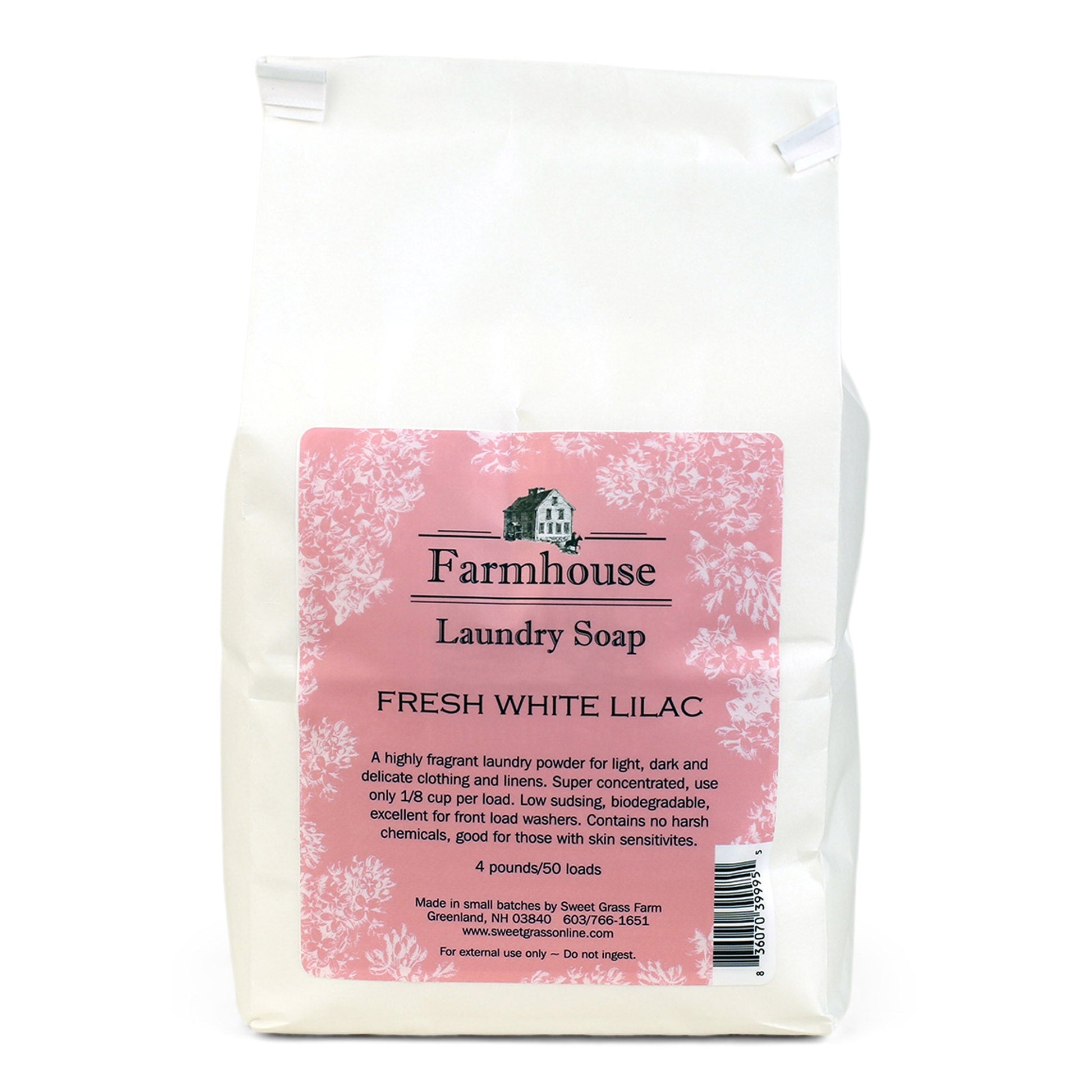 A white package of Farmhouse Laundry Soap with a label showing 'Fresh White Lilac' scent. The package is marked as eco-friendly and says it is suitable for 50 loads of laundry.