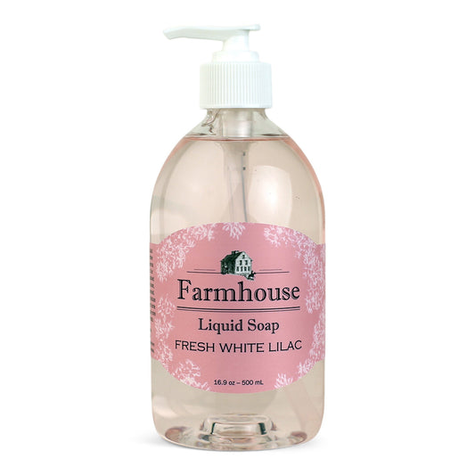 A clear pump bottle of Farmhouse liquid soap with a pink label that reads 'Liquid Soap' and 'Fresh White Lilac'.