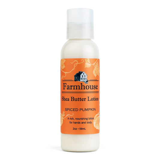 A mini bottle of Farmhouse Shea Butter Lotion with the label showing 'Spiced Pumpkin'.