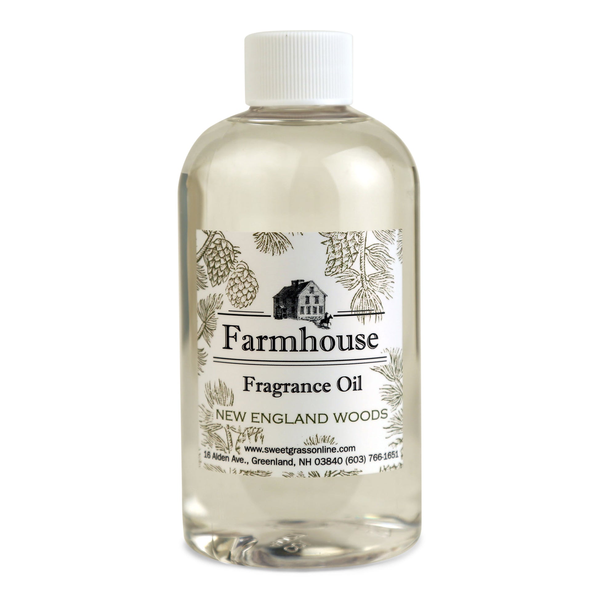 A refill bottle of Farmhouse fragrance oil labeled 'New England Woods, intended for use with diffuser sticks.