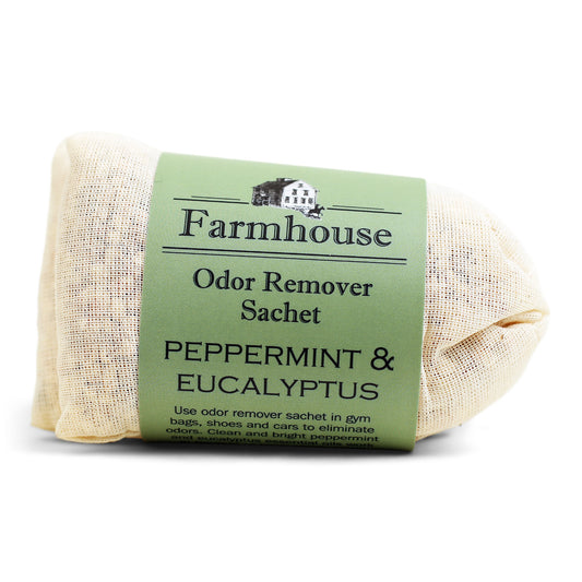 A bundle of beige linen sachets with a light green label that reads 'Farmhouse Laundry Sachets PEPPERMINT & EUCALYPTUS'.