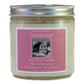 A soy wax candle jar with a label that reads 'Farmhouse Soy Wax Candle, Fresh White Lilac, Extra Fragrant - Burns Clean', with a picture of a house and the brand name 'Sweet Grass Farm'.