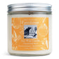 A soy wax candle jar with a label that reads 'Farmhouse Soy Wax Candle, Tangerine Mint, Extra Fragrant - Burns Clean', with a picture of a house and the brand name 'Sweet Grass Farm'.