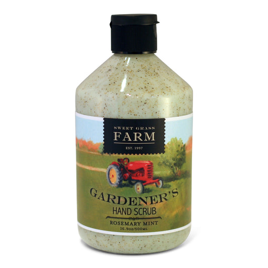 A bottle of Gardener's Natural Hand Scrub with a label featuring a red tractor and green field. The cap is black, and the scrub appears to be a speckled beige color, indicating exfoliants.