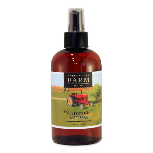 A bottle of Gardener's Insect Spray with a label featuring an illustration of a red tractor on a field. The brand 'Sweet Grass Farm' is written at the top.