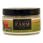 A jar of Gardener's Muscle Balm by Sweet Grass Farm with a label featuring a red tractor and a description of the product as a muscle balm.