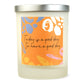 A white soy wax candle with a label that has 'Today is a good day to have a good day' written on it and colorful abstract shapes.