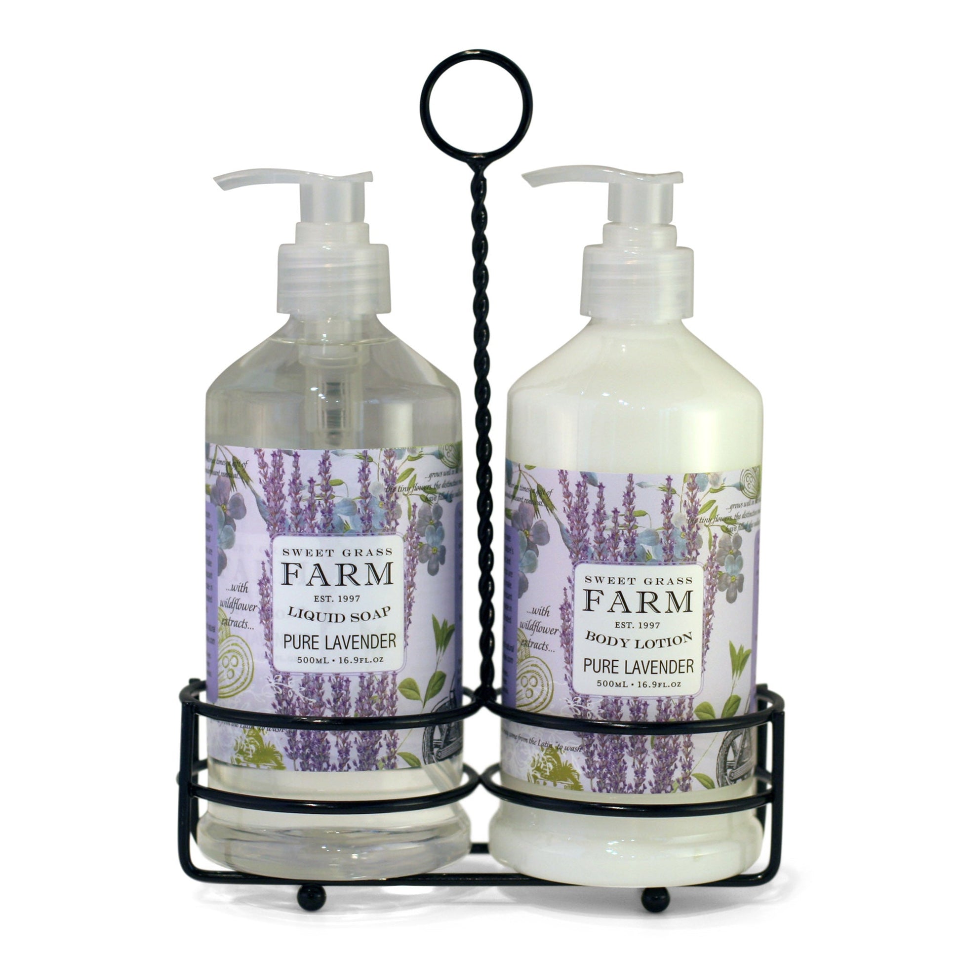 Two pump bottles of body lotion and liquid soap in a black metal caddy, with labels indicating the product Sweet Grass Farm, Meadow Collection, pure lavender scent