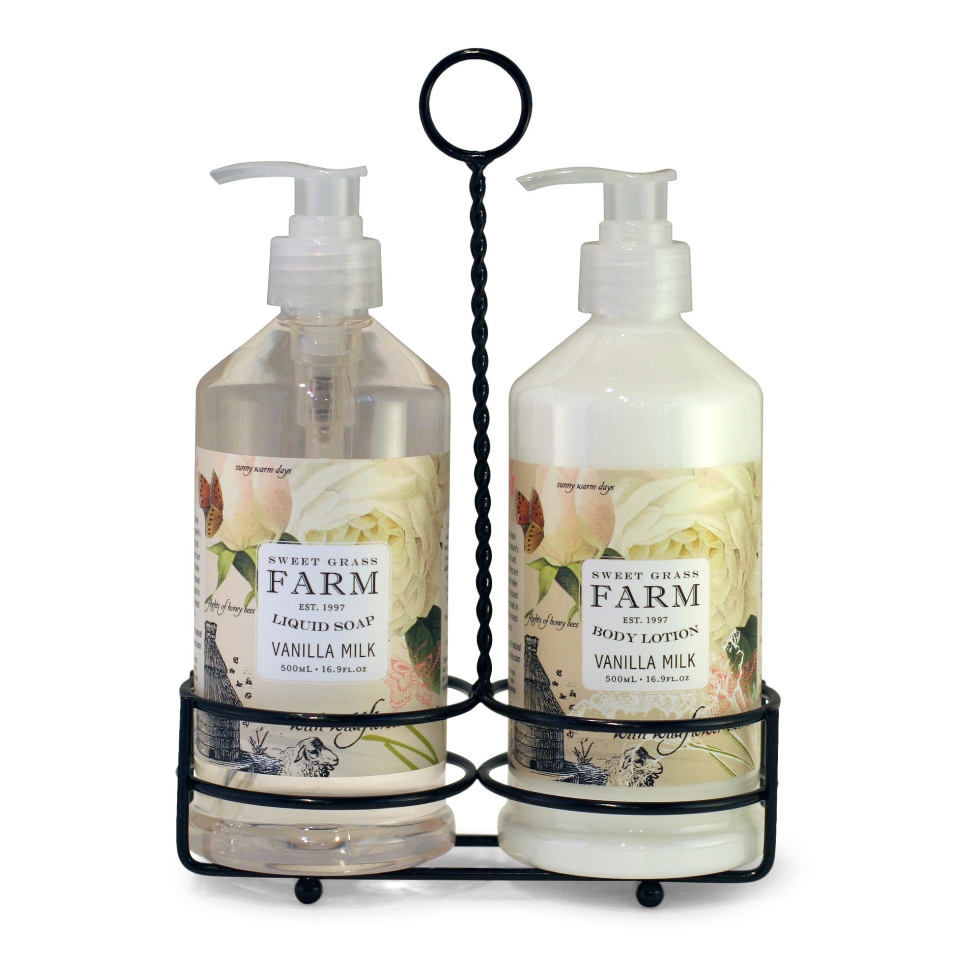 Two pump bottles of body lotion and liquid soap in a black metal caddy, with labels indicating the product Sweet Grass Farm, Meadow Collection, vanilla milk scent