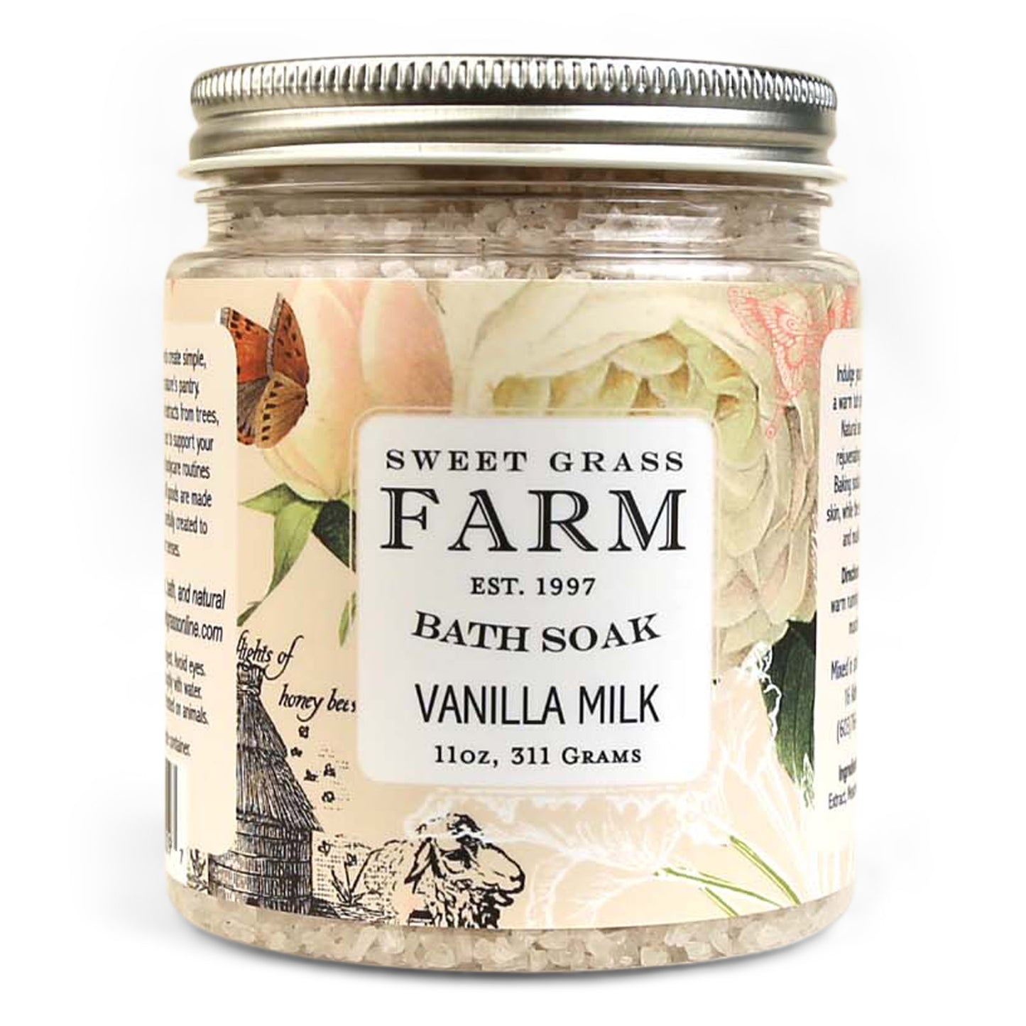 A jar of Sweet Grass Farm bath soak with a label that reads 'BATH SOAK VANILLA MILK 11oz, 311 Grams'. The jar is filled with beige bath salts.